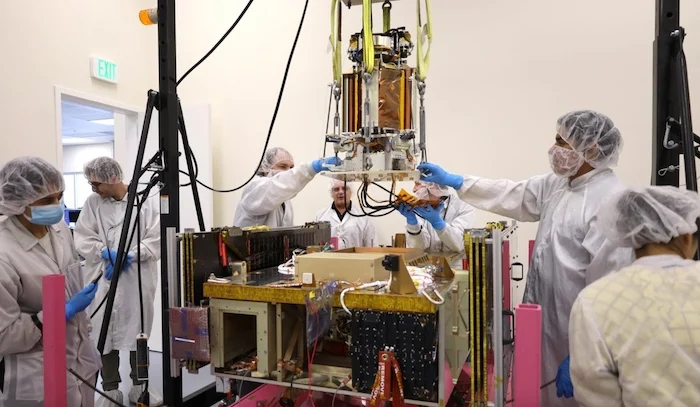 Engineers attaching DOLCE to the Momentus Vigoride spacecraft