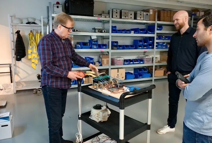 Óskar Valtýsson (left), Ósvaldur Knudsen (middle), and All About Circuit contributing writer Jake Hertz (right) looking at the original LKX-MULTI prototype