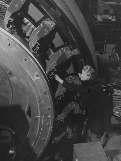 A picture of Gertrude Entwisle working on a motor she designed.